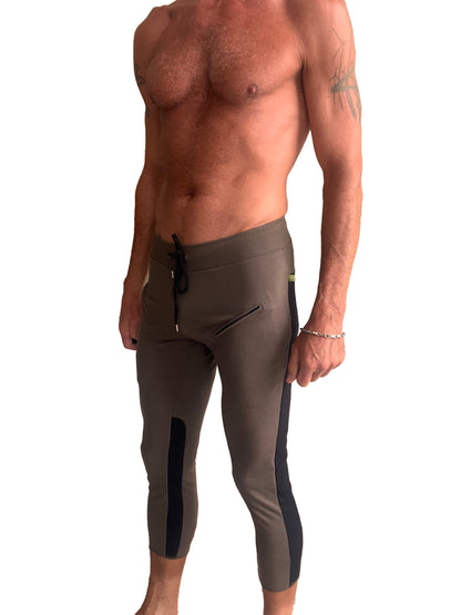 Mens olive green athletic capri yoga pants with black side panels and drawstring waistband for activewear use