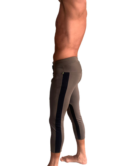Mens army green capri yoga pants with black vertical stripes and high-waisted design for athletic use