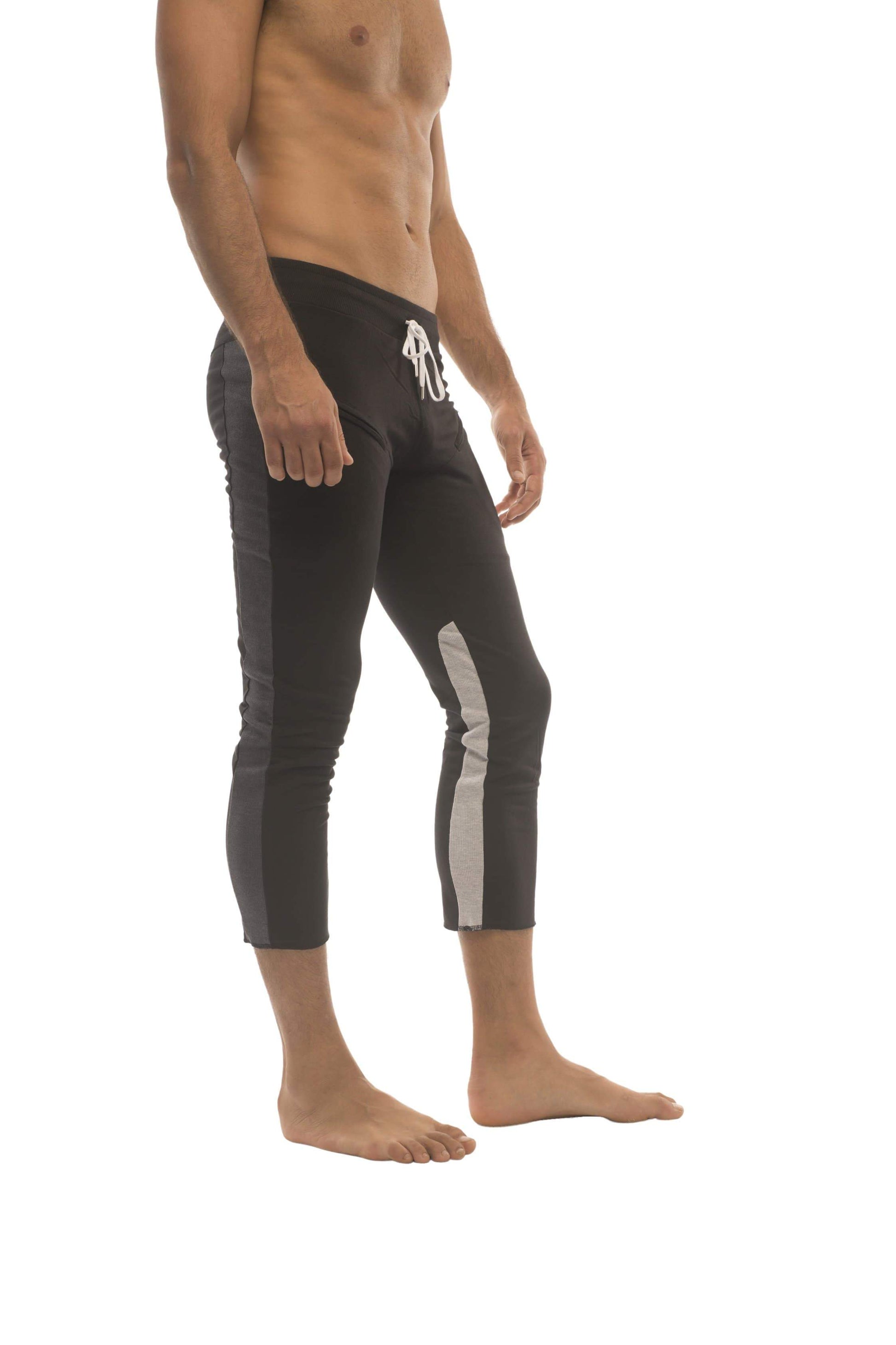 Mens black capri yoga pants with gray side panels and white logo on waistband featuring 4/5 zipper pockets
