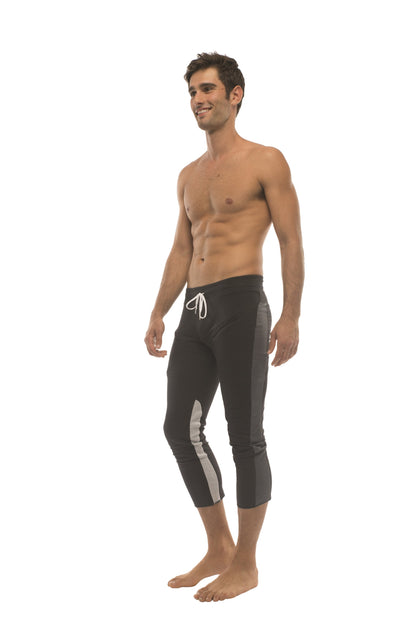 Mens black capri-style swim trunks with white drawstring gray side stripes and zipper pockets for active use