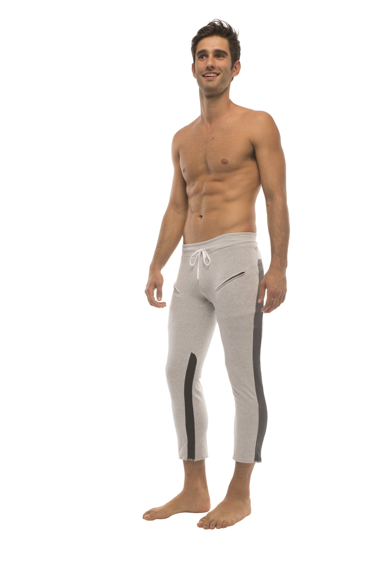 Mens 4/5 zipper pocket capri yoga pants in grey with black side stripes and white drawstring waistband for athletic use