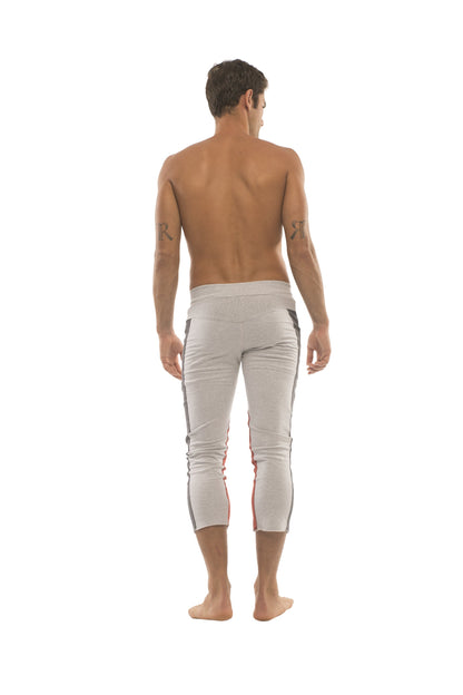 White athletic capri pants with black and red side stripes designed for men with zipper pockets for yoga and workouts