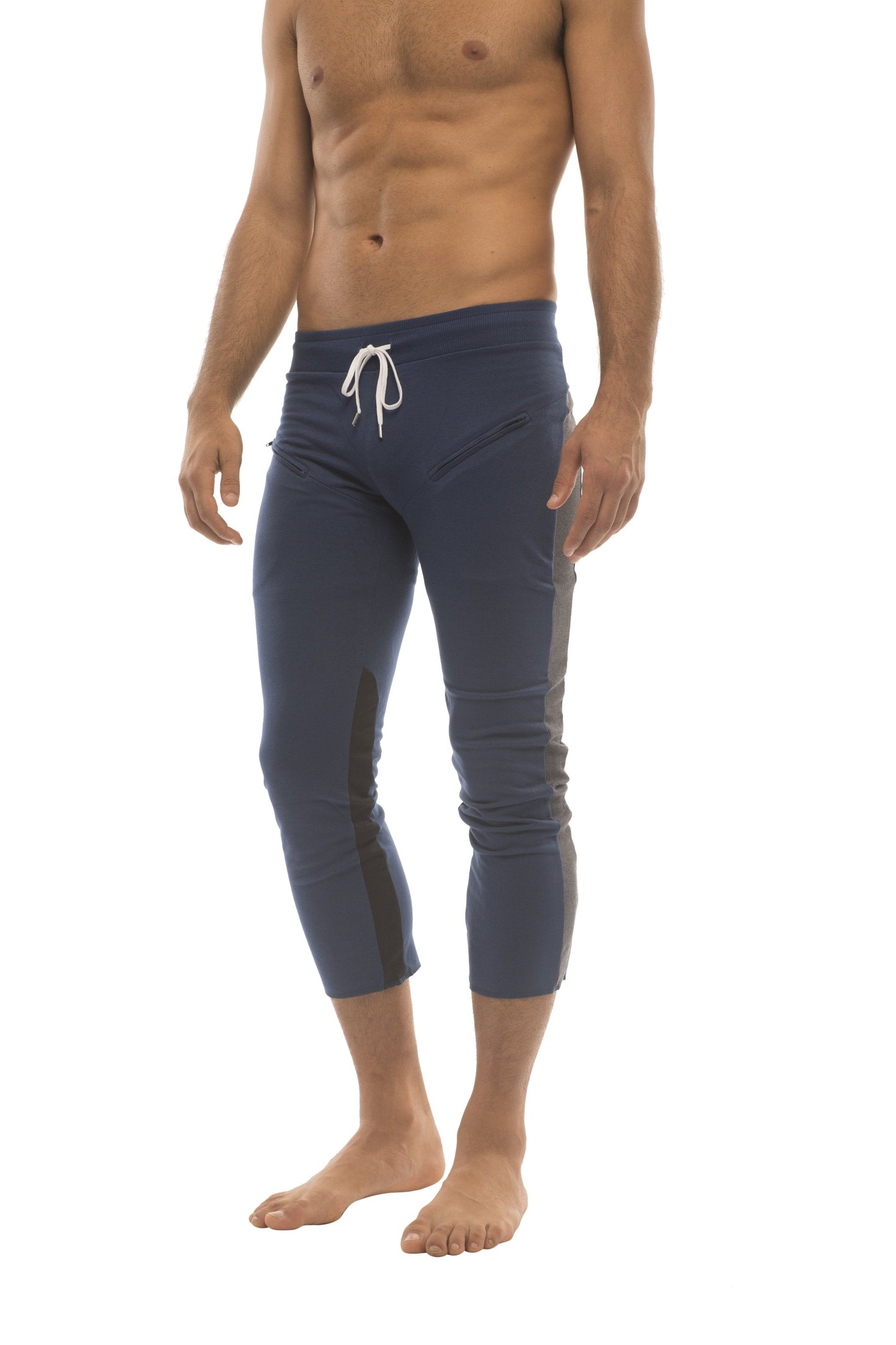 Mens navy blue capri yoga pants with white drawstring waistband and black side panels featuring zipper pockets