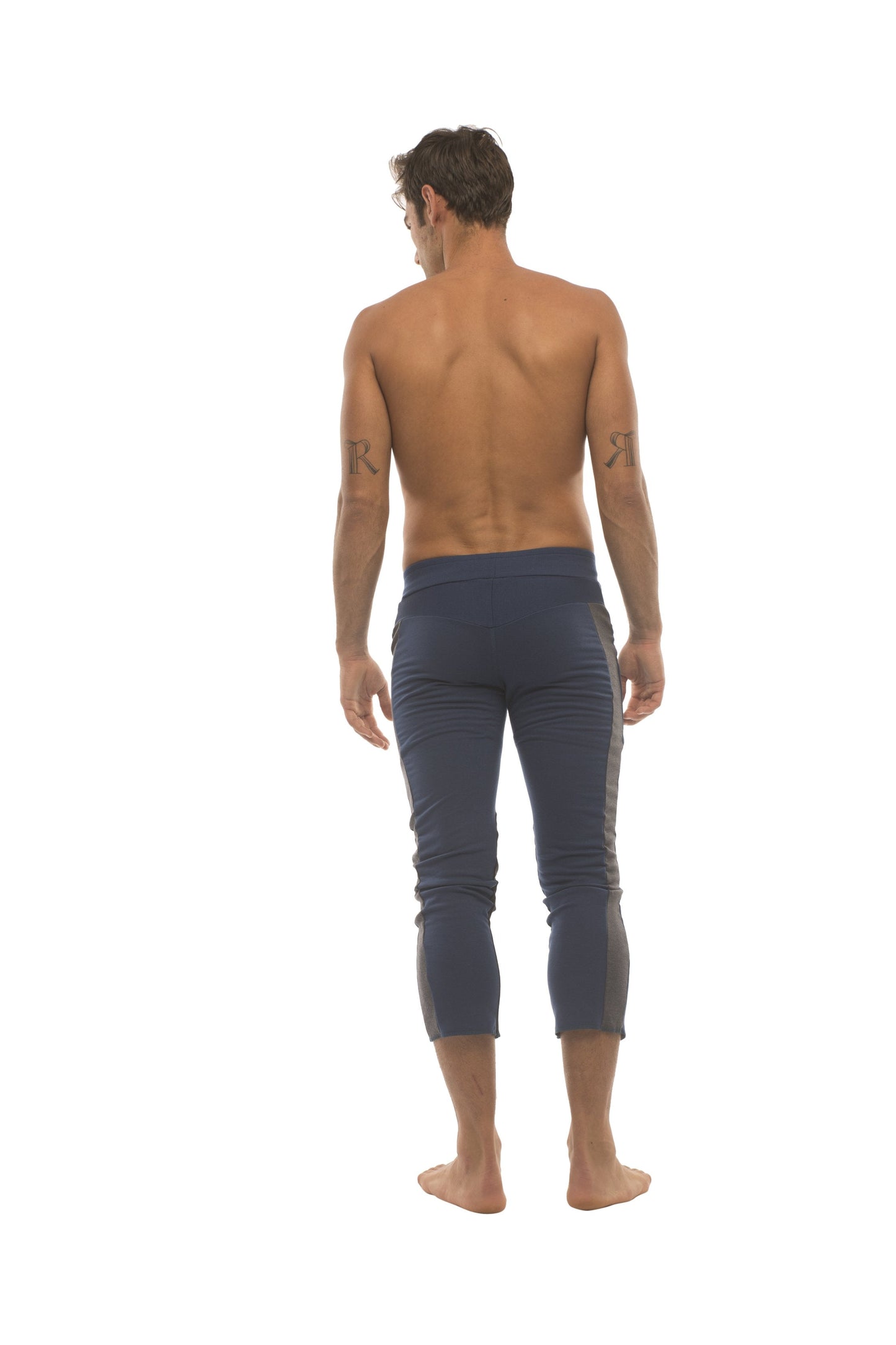 Navy blue mens capri yoga pants with subtle side stripes and 4 5 zipper pockets for active wear