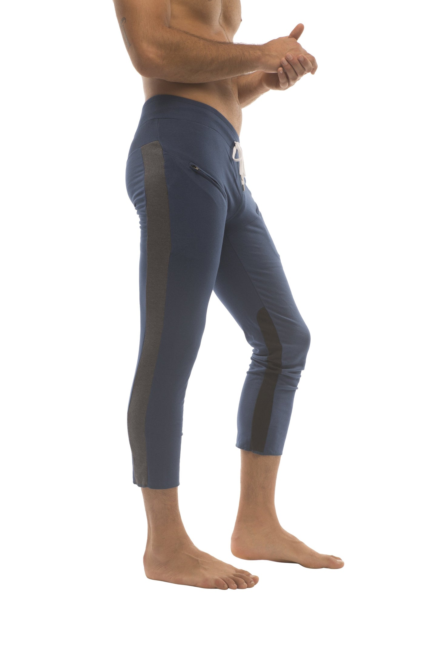 Mens 4/5 zipper pocket capri yoga pants in navy blue with black side panels and white drawstring waistband