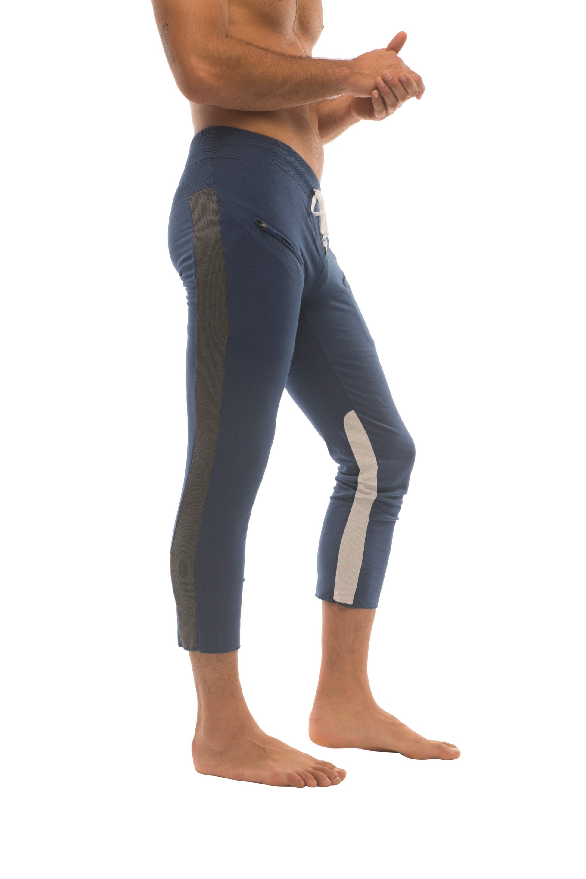 Mens navy blue athletic capri yoga pants with dark green and white side stripes and 45 zipper pockets