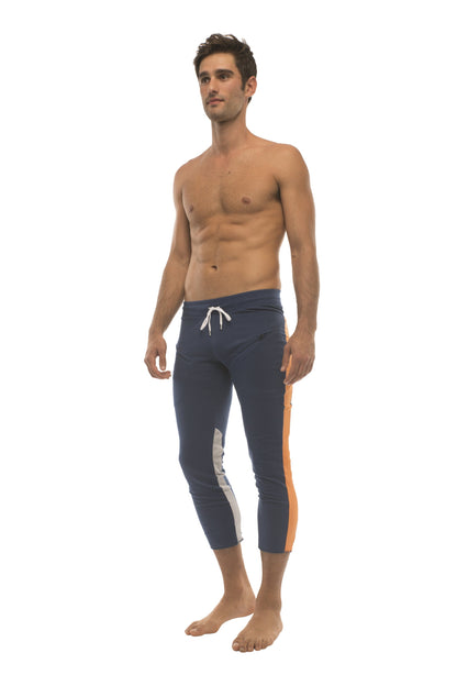 Mens royal navy blue 4/5 zipper pocket capri yoga pants with white and orange side stripes and drawstring waistband