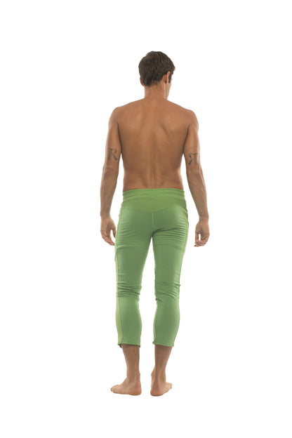 A pair of mens vibrant solid bamboo green 4/5 zipper pocket capri yoga pants with smooth stretchy fabric