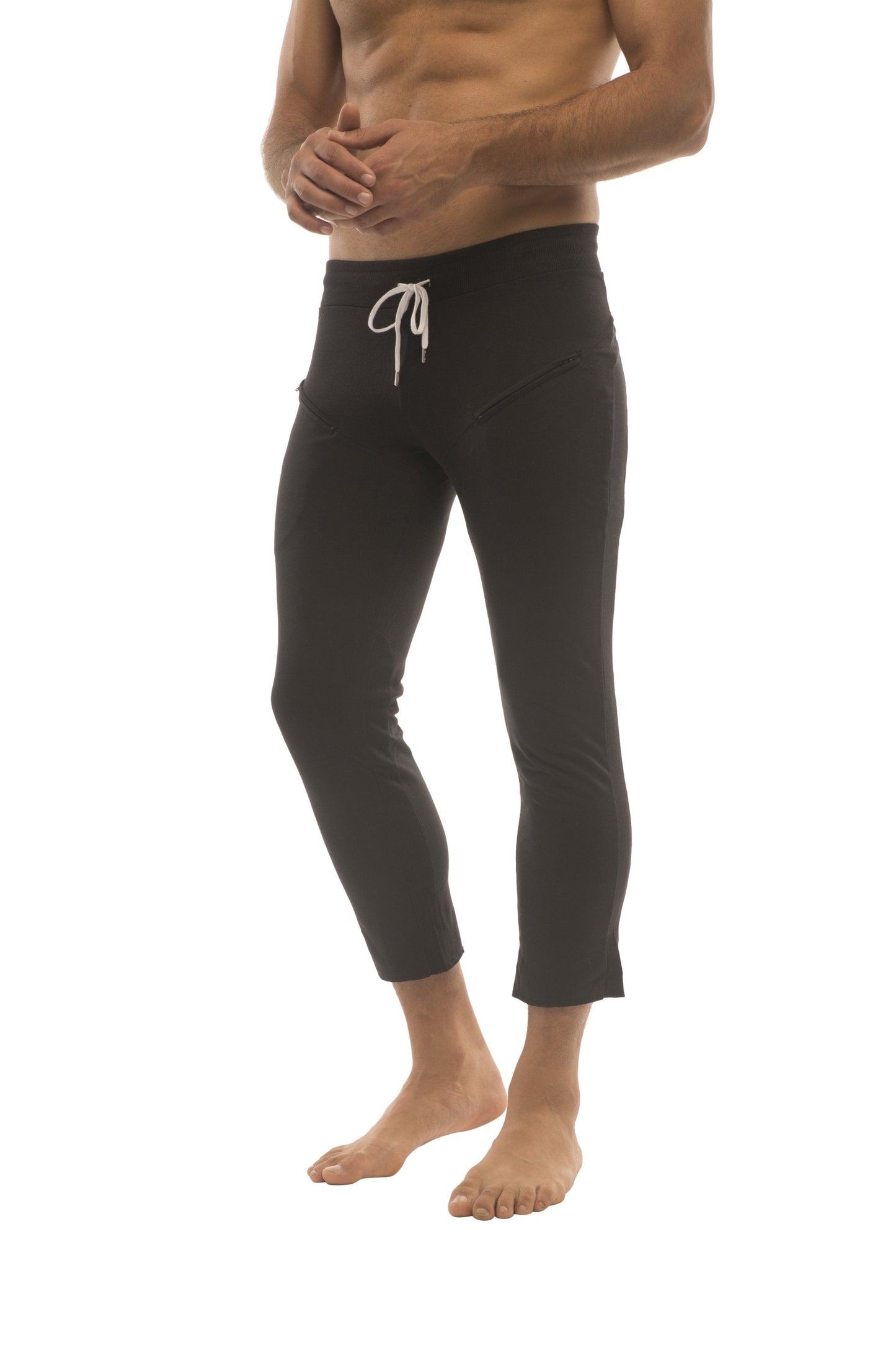Mens 4/5 zipper pocket capri yoga pants in solid black with a white drawstring waistband and cropped fit