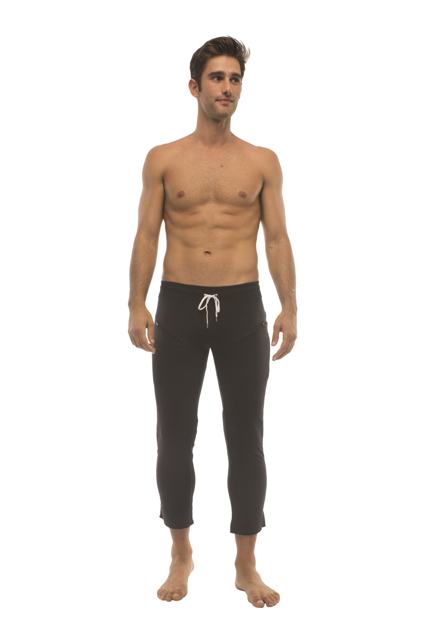 Mens solid black capri yoga pants with white drawstring waistband and side zipper pockets for activewear