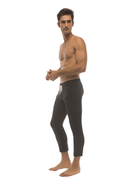 Mens solid black cropped leggings with a white drawstring waistband designed for yoga and active wear