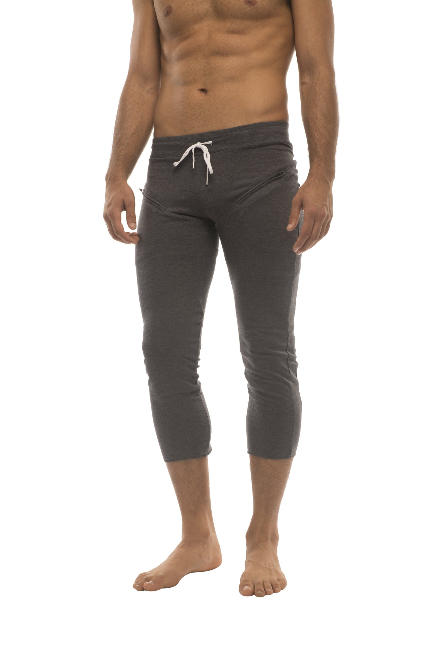 Dark gray mens capri-length yoga pants with white drawstring waistband and side pockets for active wear