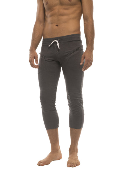 Dark gray mens capri-length yoga pants with white drawstring waistband and side pockets for active wear