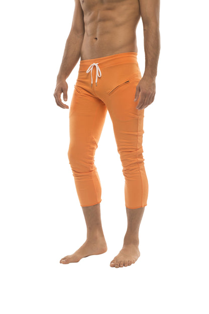 Mens solid orange 4/5 zipper pocket capri yoga pants with bright orange swim trunks style and white drawstring waistband