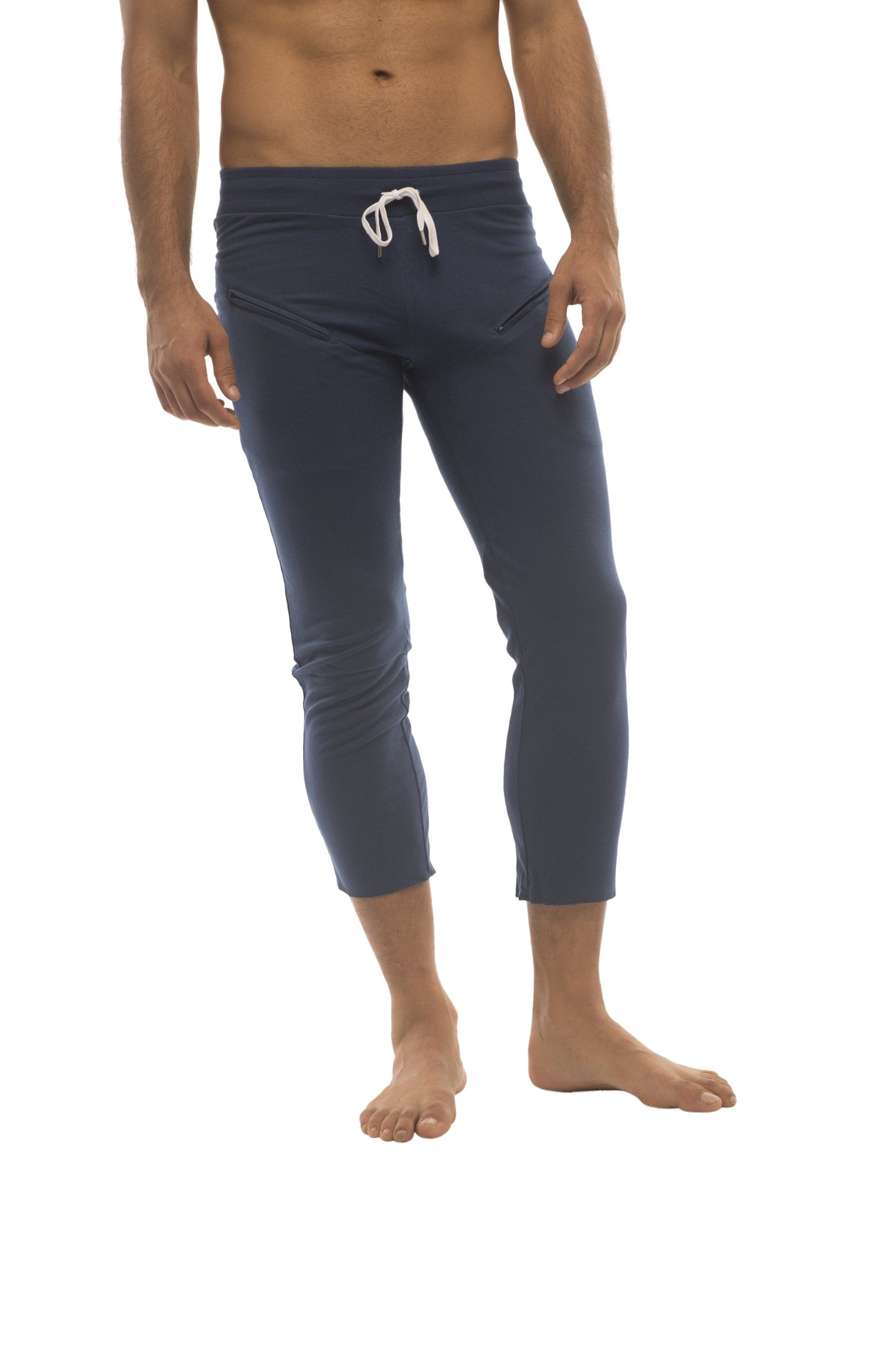 Navy blue capri length men’s yoga pants with 45 zipper pockets and white drawstring waistband for athletic use