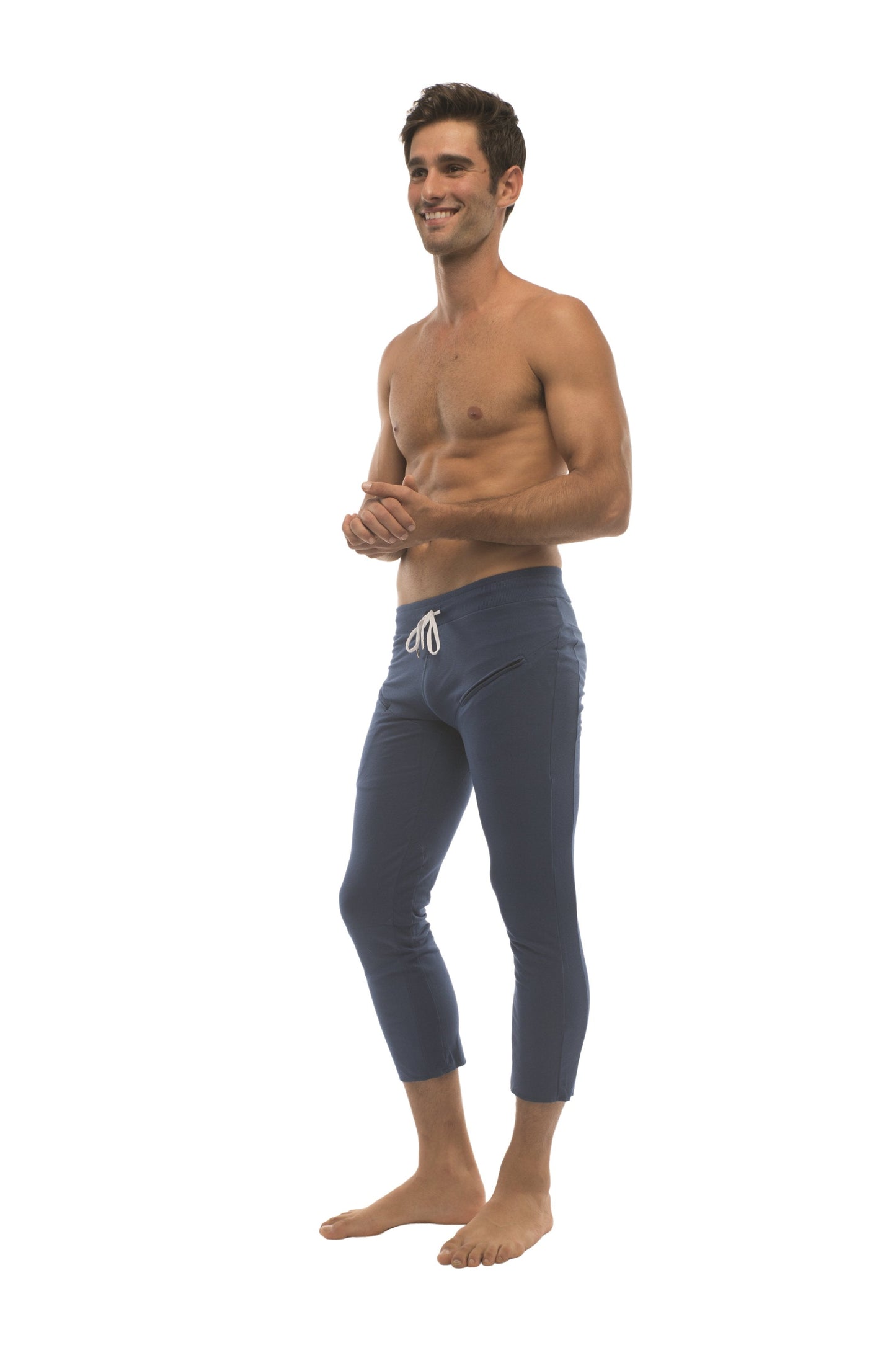 Mens solid royal blue capri yoga pants with white drawstring waistband and 4/5 zipper pockets for active wear