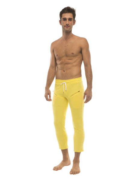Mens 4/5 zipper pocket capri yoga pants in bright yellow with white drawstring waistband and side pockets