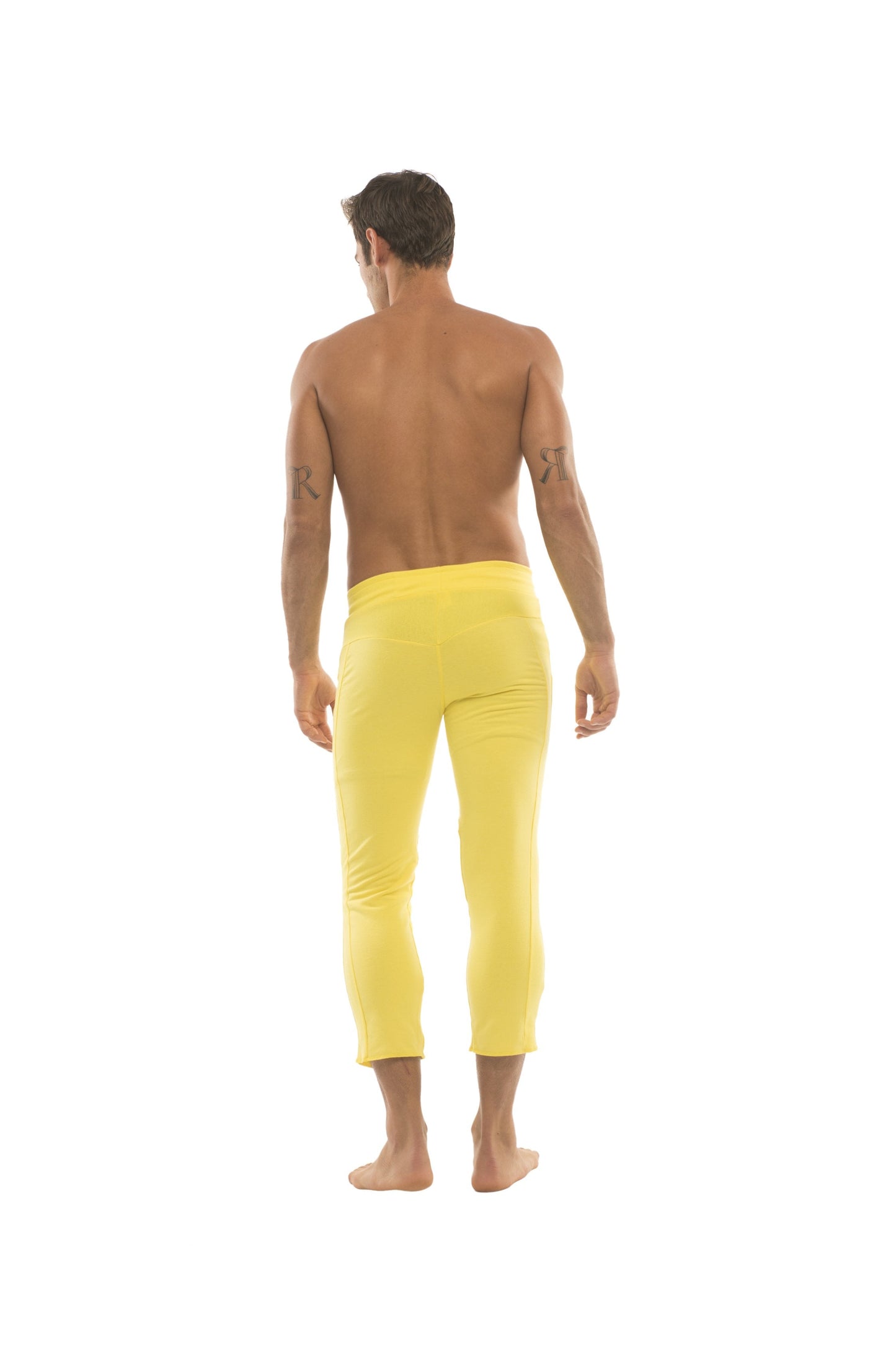 Mens solid yellow capri yoga pants with 4 5 zipper pockets in bright yellow form fitting fabric