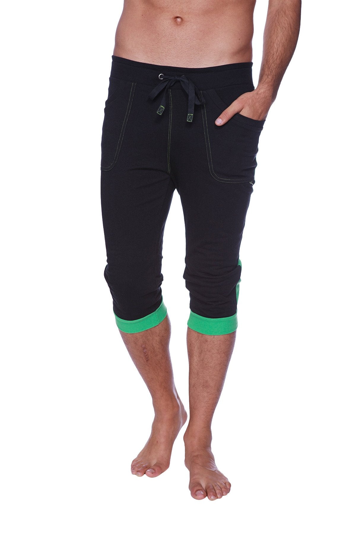 Mens cuffed yoga pants in black with green trim at cuffs and pockets featuring a drawstring waistband