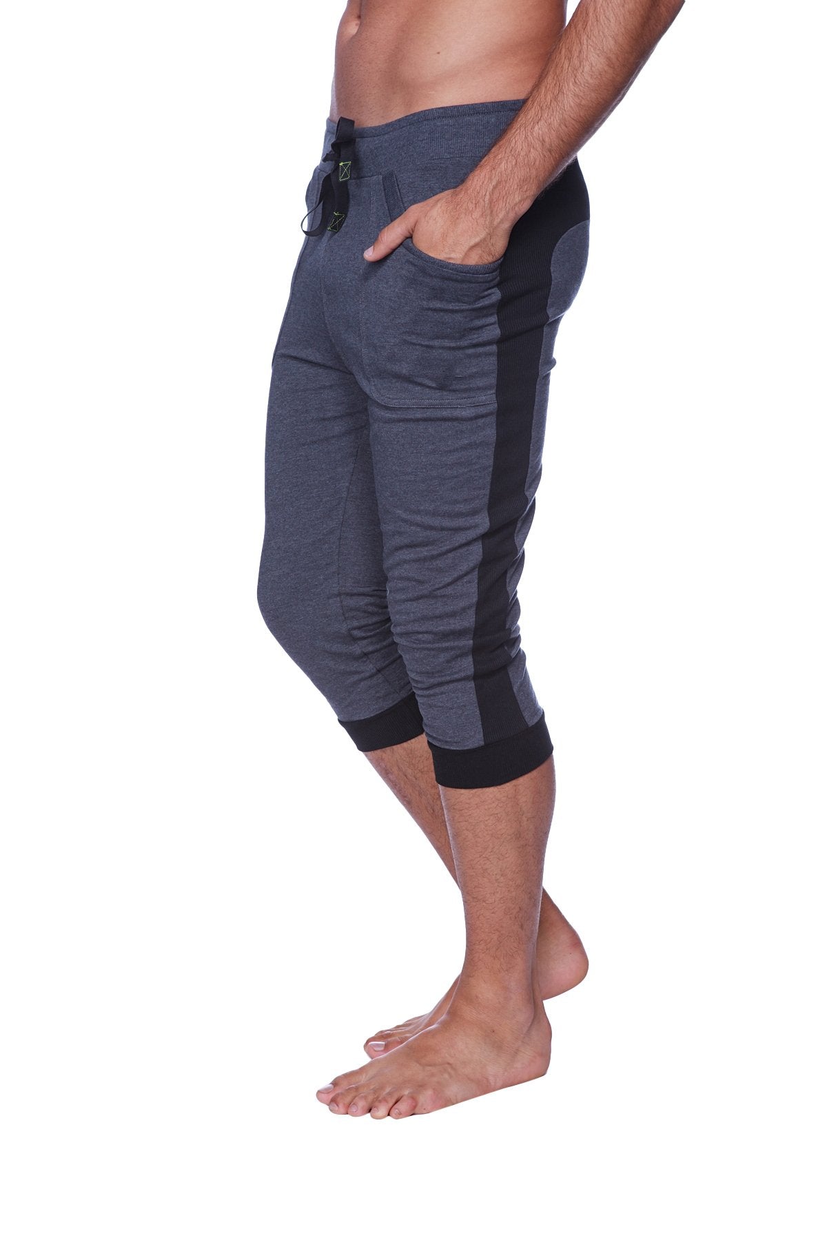 Mens cuffed yoga pants in charcoal with black side panels featuring elastic cuffs and capri-length jogger style