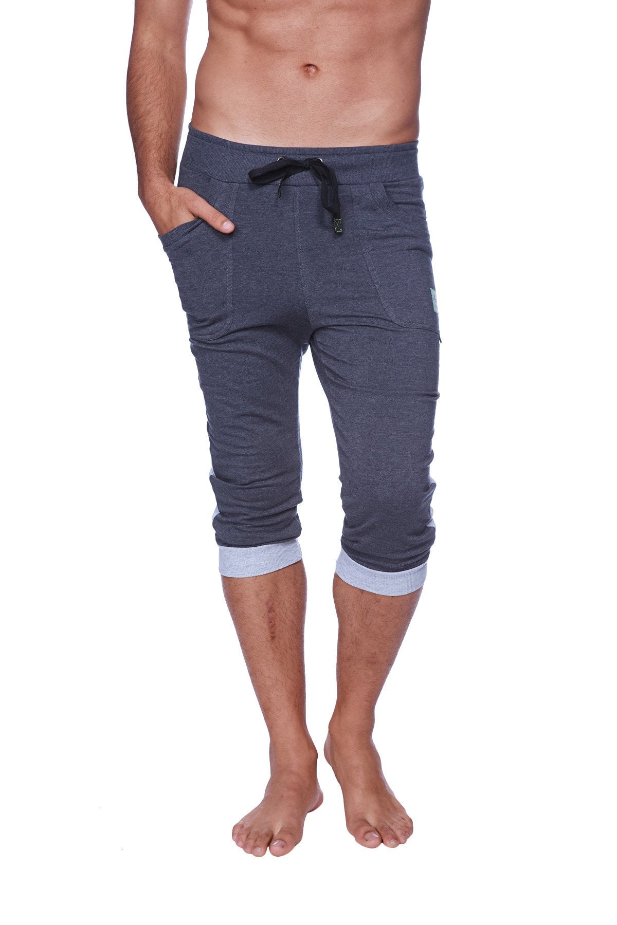 Mens cuffed yoga pants in charcoal heather grey with dark gray fabric, black drawstring waistband, and light blue cuffs
