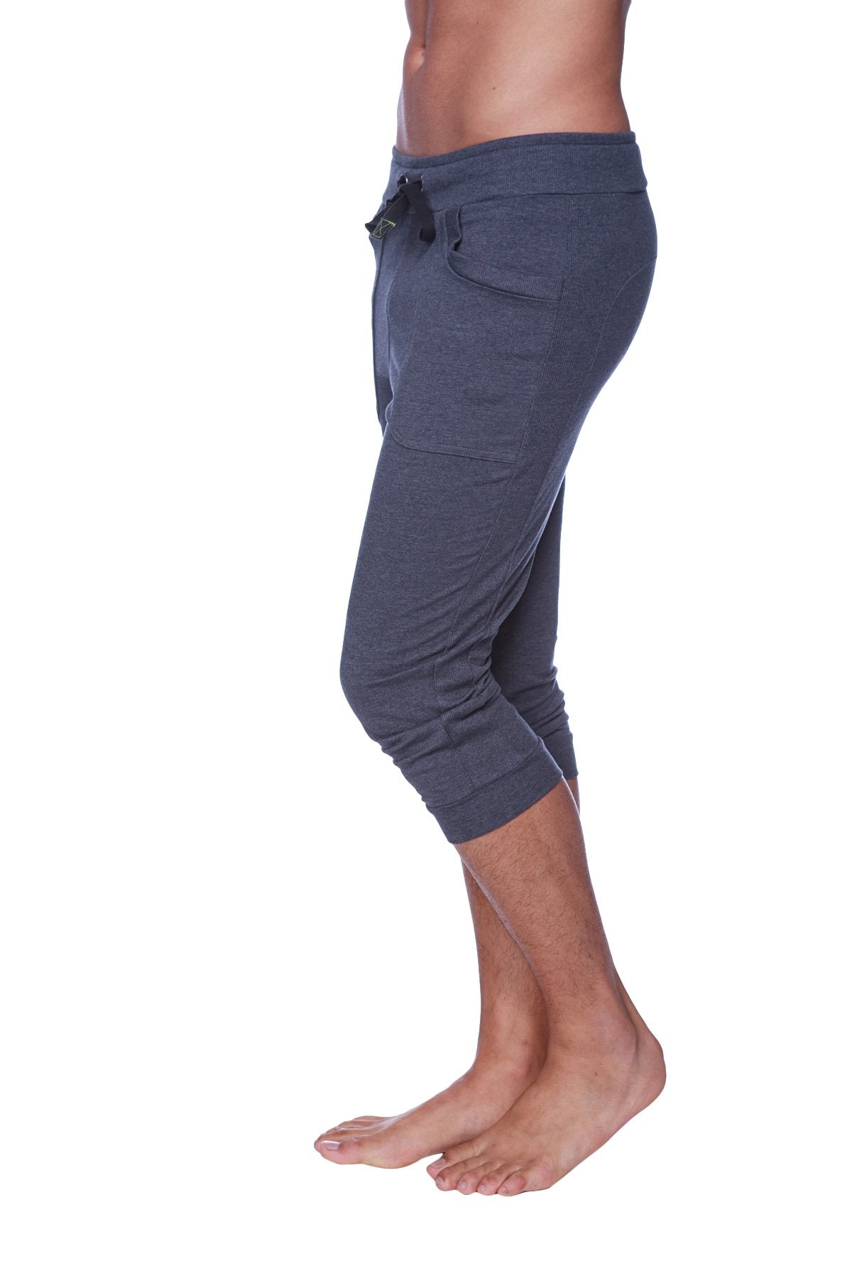 Mens cuffed yoga pants in solid charcoal with soft texture, drawstring waistband, and side pockets