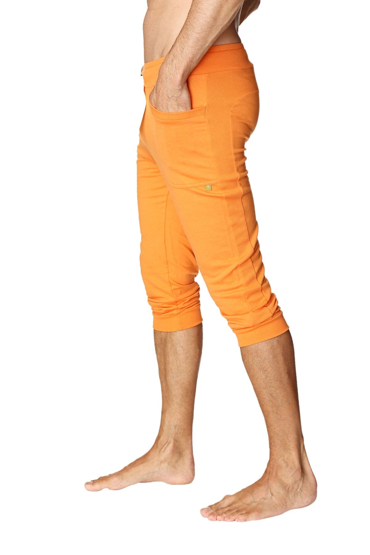 Mens cuffed yoga pants in solid sun orange with a relaxed fit and multiple pockets for casual comfort