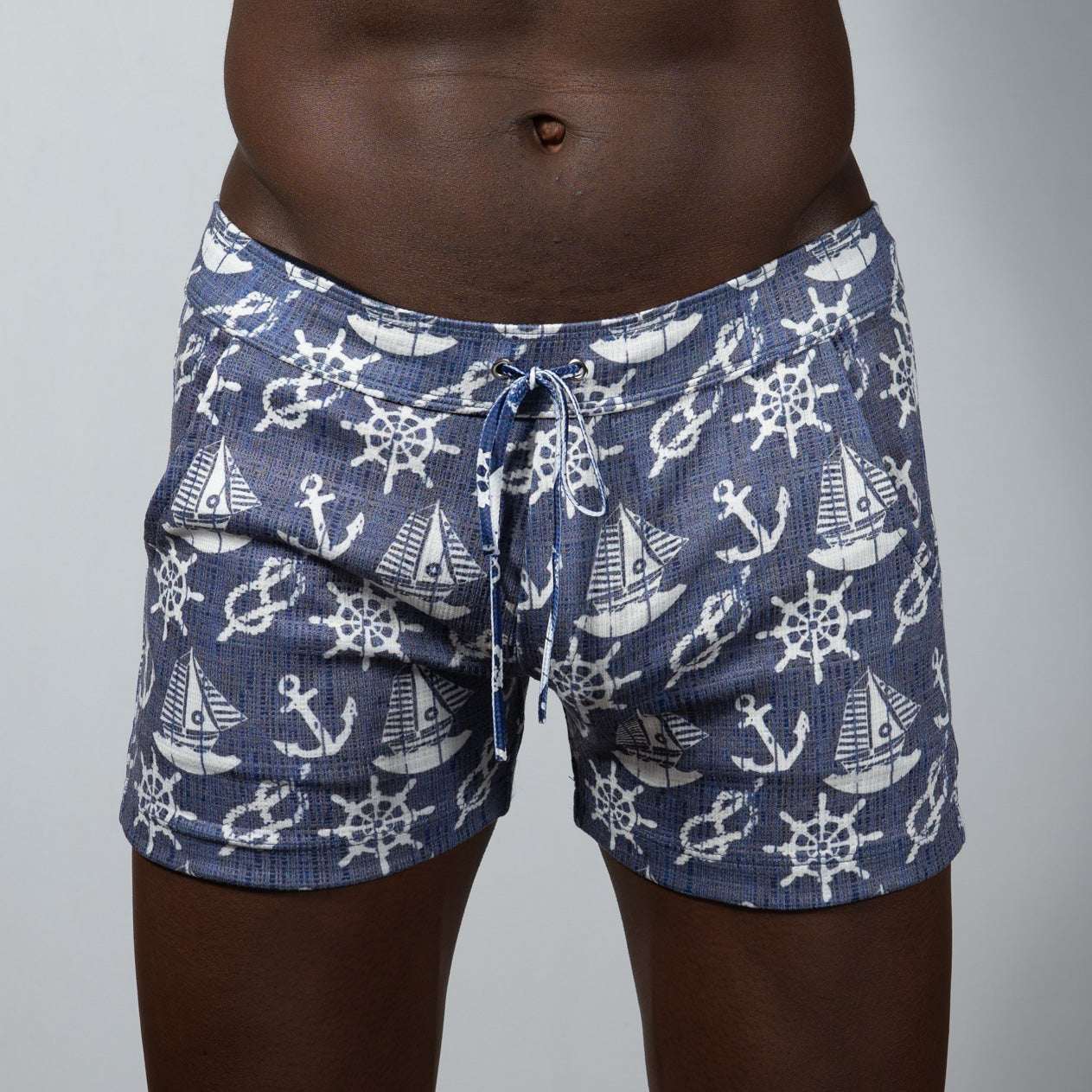Navy blue nautical linen texture shorts with white anchor sailboat and ship wheel pattern swim trunks