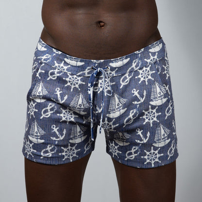 Navy blue nautical linen texture shorts with white anchor sailboat and ship wheel pattern swim trunks