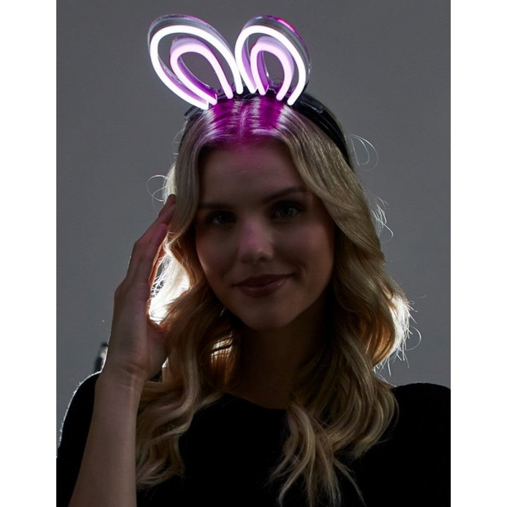 Purple neon bunny ears headband glowing with bright light for festive and party wear accessory
