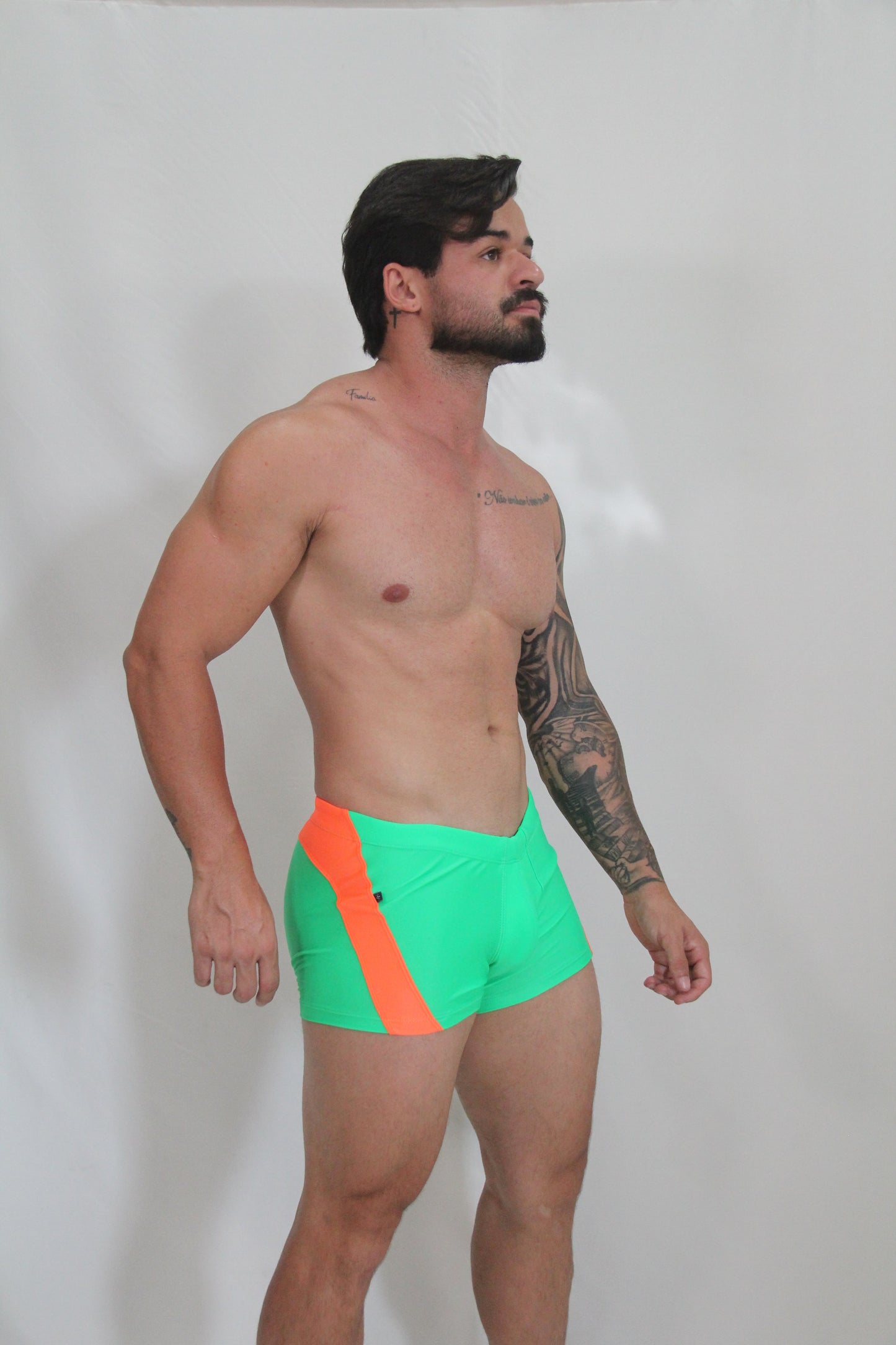 Neon curved sq cut trunk with vibrant neon green swim trunks featuring a bold orange diagonal stripe
