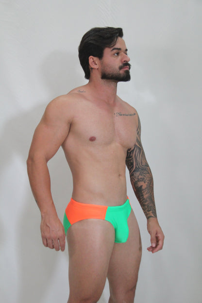 Neon curved swim brief featuring vibrant two-tone neon orange and electric green colors with a sleek modern cut
