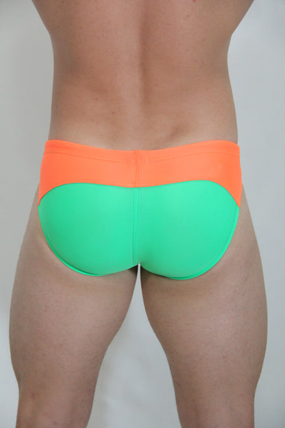 Neon curved swim brief in bright orange and neon green two-tone design perfect for vibrant swimwear style
