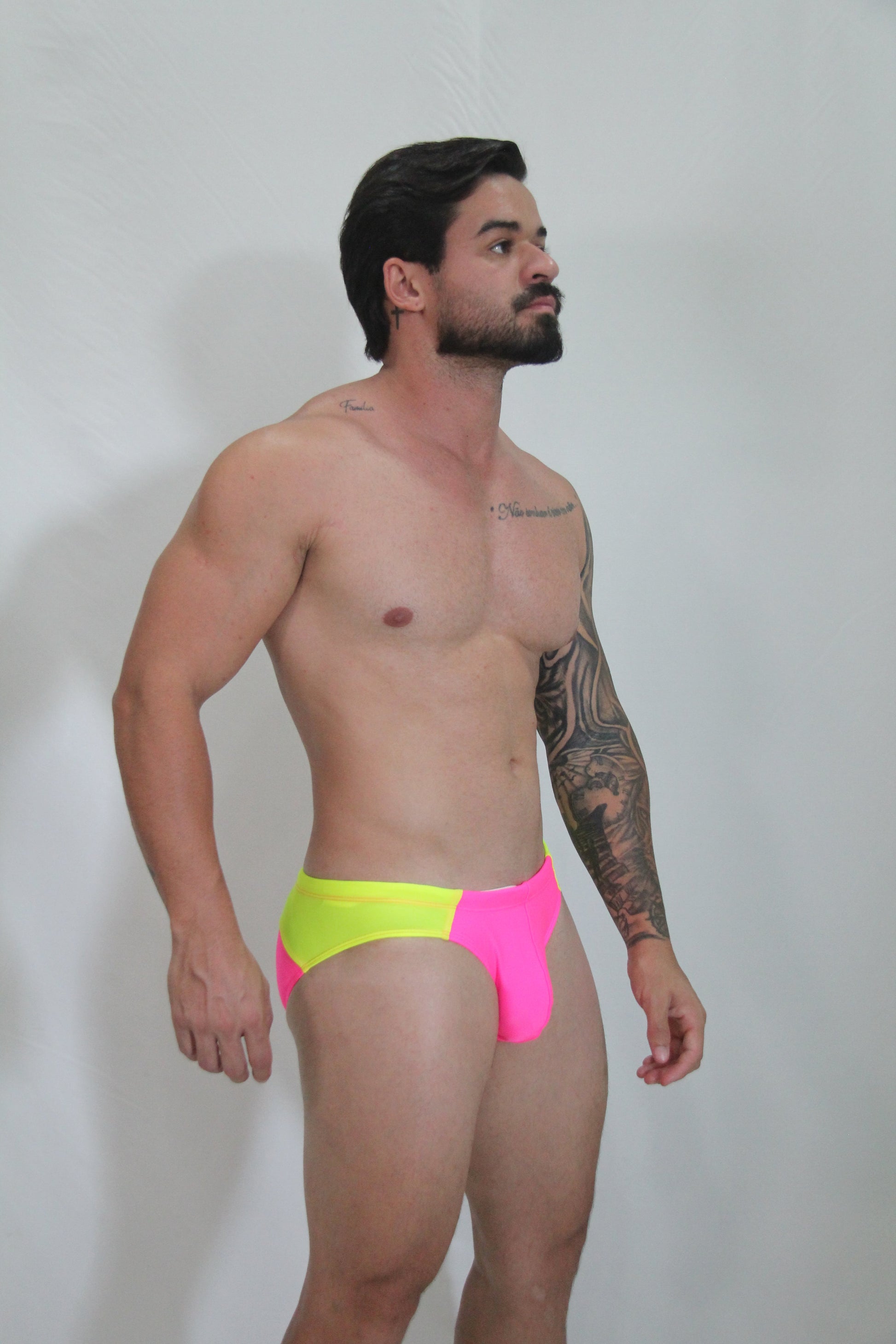 Neon curved swim brief featuring vibrant neon yellow and pink two-tone design with bold modern style swim trunks
