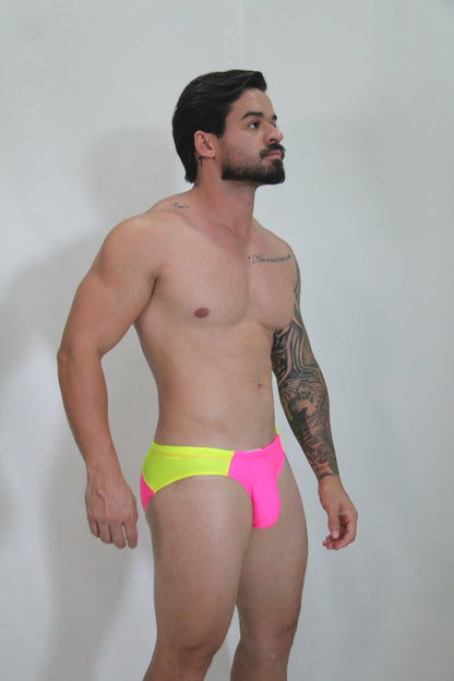 Neon curved swim brief featuring vibrant neon yellow and pink two-tone design with bold modern style swim trunks