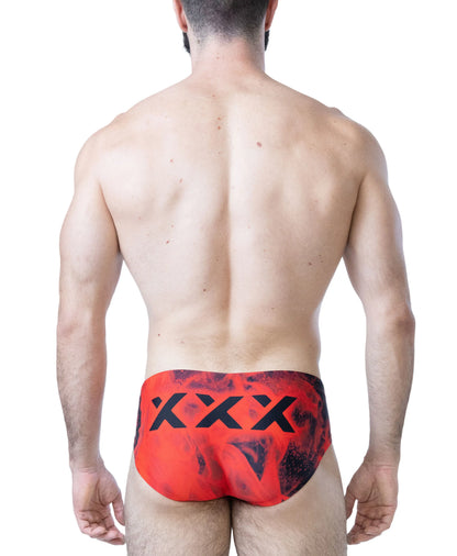 Red and black bikini swimwear with a flame pattern featuring a bold logo on the back worn by a model from behind by Nasty Pig