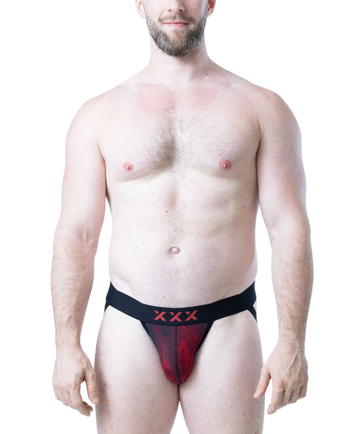 Model wearing a red and black jockstrap with a flame pattern and black waistband featuring red logo by Nasty Pig