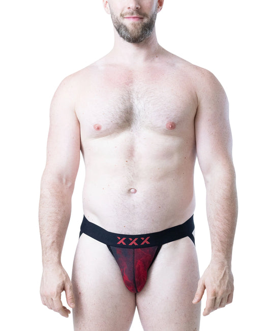Model wearing a red and black jockstrap with a flame pattern and black waistband featuring red logo by Nasty Pig