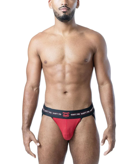 Model wearing a black and red mesh jockstrap by Nasty Pig featuring a logo waistband and a snug fit.