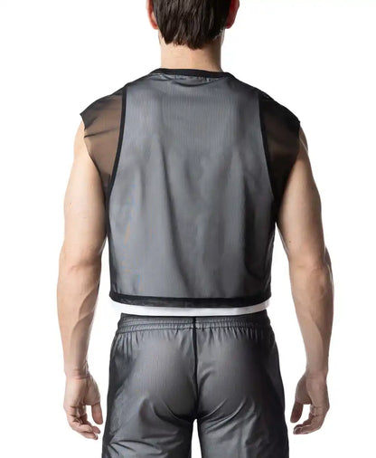 Rear view of a person wearing a Nasty Pig Blur Crop Top, a black mesh sleeveless top.