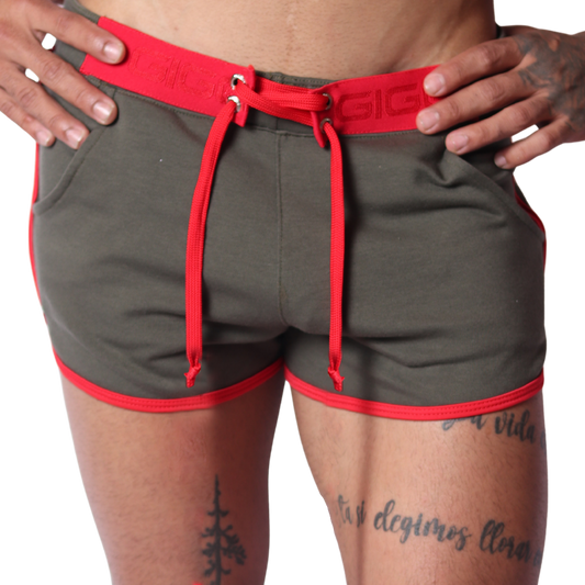 Front view of Gigo Nafts green jersey shorts with red trim, lace-up waistband, and drawstring detail.