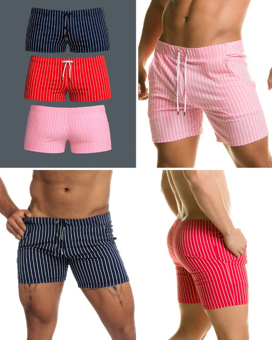 Three pairs of short, vertically striped swim trunks in navy, red, and pink with white drawstring waistbands.
