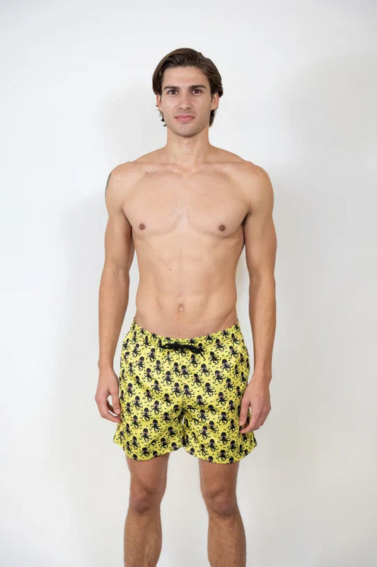 Bright yellow octopus print swim shorts featuring a repeating black octopus pattern for beachwear use