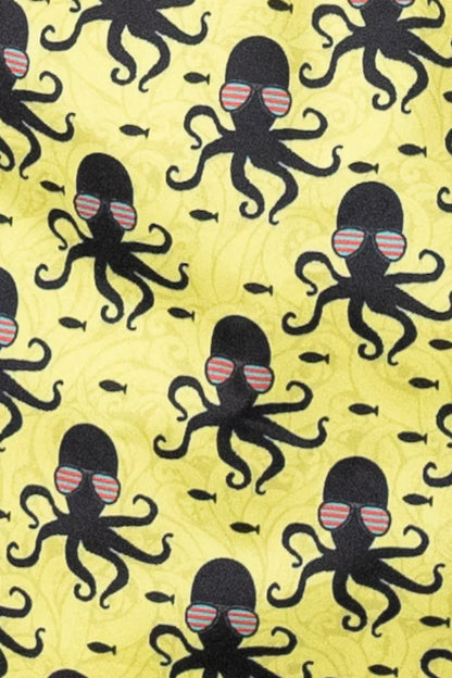 Yellow octopus print swim short fabric with black octopuses wearing striped sunglasses and small fish pattern