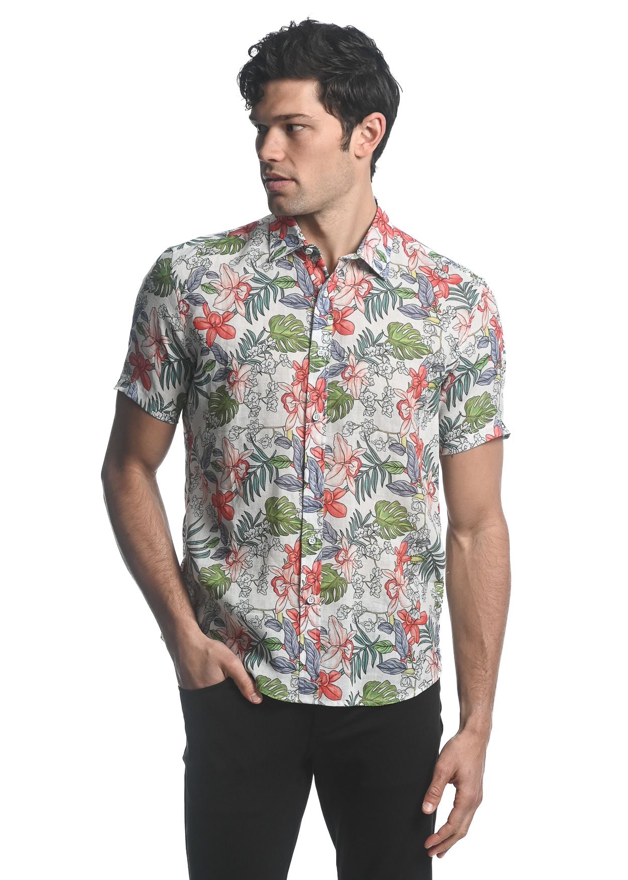 A man wearing an orchids tencel linen short-sleeved woven shirt with red green and gray tropical floral pattern on beige