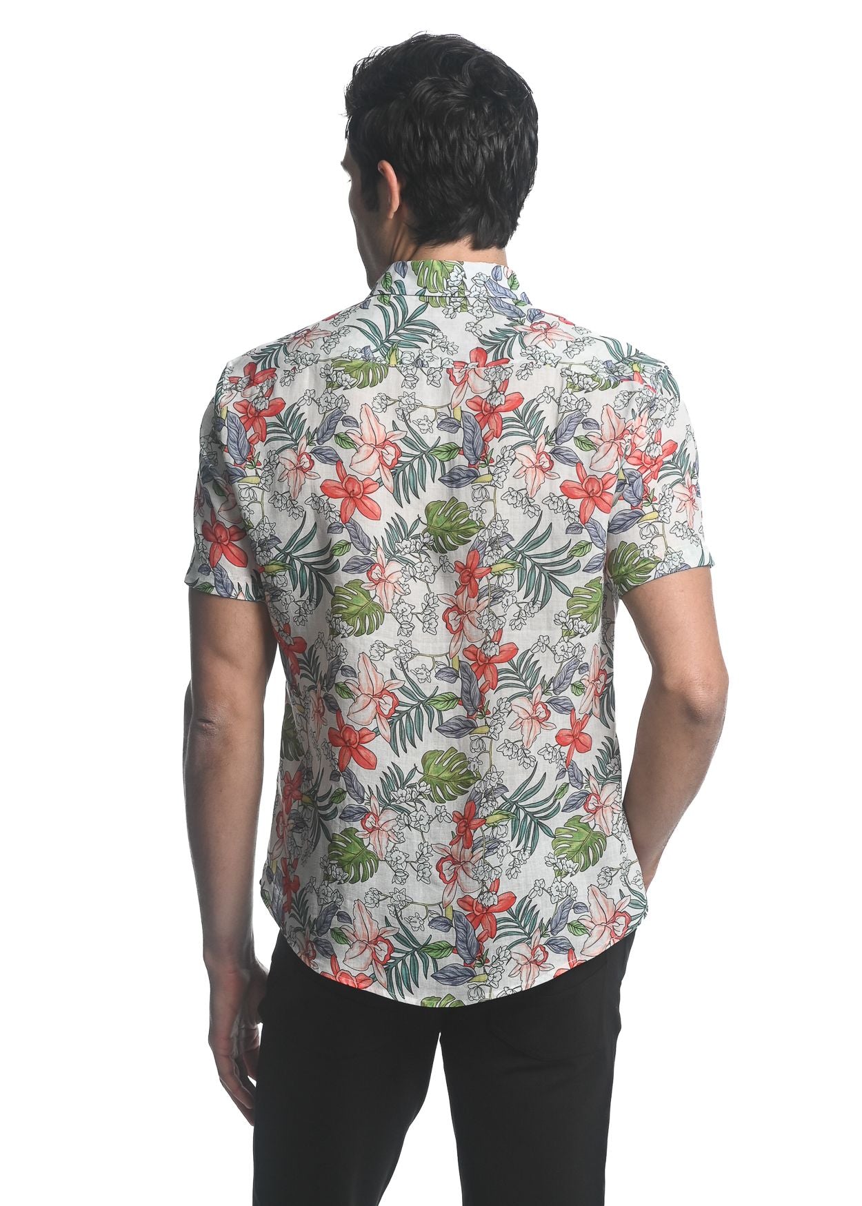 A man wearing an orchids tencel linen short-sleeved woven shirt with a vibrant red green and gray floral pattern on off-white