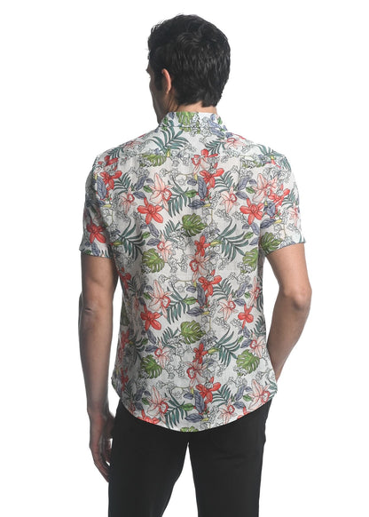 A man wearing an orchids tencel linen short-sleeved woven shirt with a vibrant red green and gray floral pattern on off-white