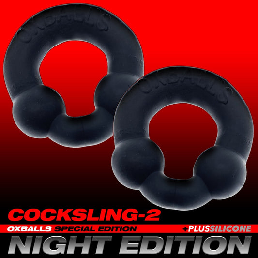 Two black OXBALLS Ultraballs on a red gradient background.