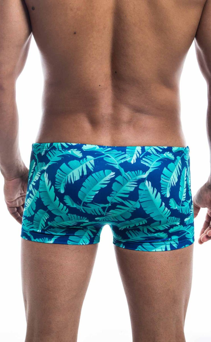 Oceanico square cut swim trunks with vibrant turquoise and deep blue tropical leaf pattern perfect for beachwear