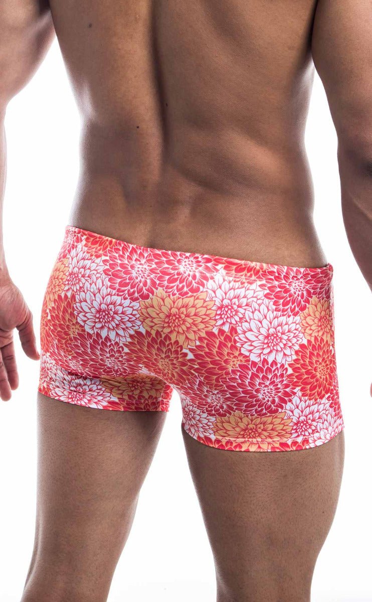 Oceanico square cut swim trunks with vibrant coral and white floral pattern and snug high waisted cut